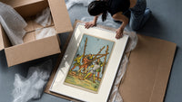 Five men fighting with staves framed print being unpacked from protective bubble wrap and a box