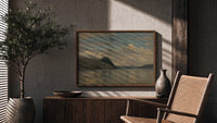Fjord landscape with mountains and water print in a wood frame above a fluted sideboard beside an olive tree