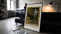 Oriental woman with peacock feather print in a slim black frame leaning on a dark sofa in a concrete print studio