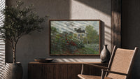Impressionist flower garden with house print in a wood frame above a fluted sideboard beside an olive tree