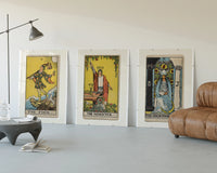 Three 1909 tarot cards three-panel set displayed beside a brown leather sofa