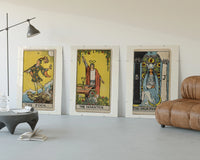 Three 1909 tarot cards three-panel set displayed beside a brown leather sofa