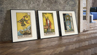 Three 1909 tarot cards three-piece set leaning on parquet beside a vintage loft door