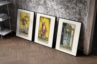Three 1909 tarot cards set of three black-framed prints leaning against a raw-plaster wall
