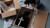 Forgiven Cross Hoodie framed print being unpacked from protective bubble wrap and a box