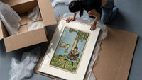 Seated man under tree with cups framed print being unpacked from protective bubble wrap and a box