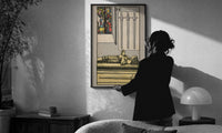 Four of Swords print in a slim black frame being hung on a sunlit wall in a monochrome room