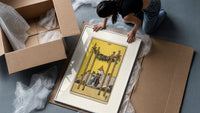 Four Wands tarot card scene framed print being unpacked from protective bubble wrap and a box