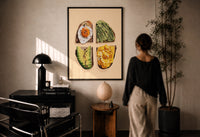 Four Toasts Grid print in a black frame on a sunlit plaster wall, a woman looking on beside a mushroom lamp
