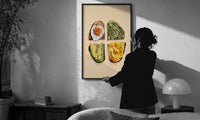 Four Toasts Grid print in a slim black frame being hung on a sunlit wall in a monochrome room