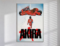 Akira red bike and rider framed anime poster on white poster in a slim frame on a bright wall with soft window light