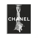 Framed Chanel black and white fashion poster with bold white CHANEL typography and an editorial figure in an open shirt