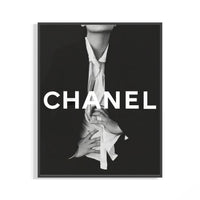 Framed Chanel black and white fashion poster with bold white CHANEL typography and an editorial figure in an open shirt