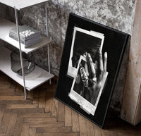 Michael Jordan six rings black and white polaroid framed poster poster in a black frame leaning beside a shelf in a…