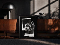 Black-framed Michael Jordan six rings black and white polaroid framed poster print on a moody console with designer…