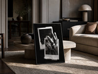 Michael Jordan six rings black and white polaroid framed poster print in a black frame leaning on a travertine table in a…