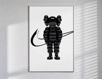KAWS Chum figure with swoosh line framed poster on white poster in a slim frame on a bright wall with soft window light
