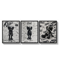 KAWS black and white graffiti framed poster set of 3 three-panel set arranged as a triptych on a bright gallery wall