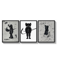 Black and white KAWS Nike framed poster set of 3 three-panel set arranged as a triptych on a bright gallery wall