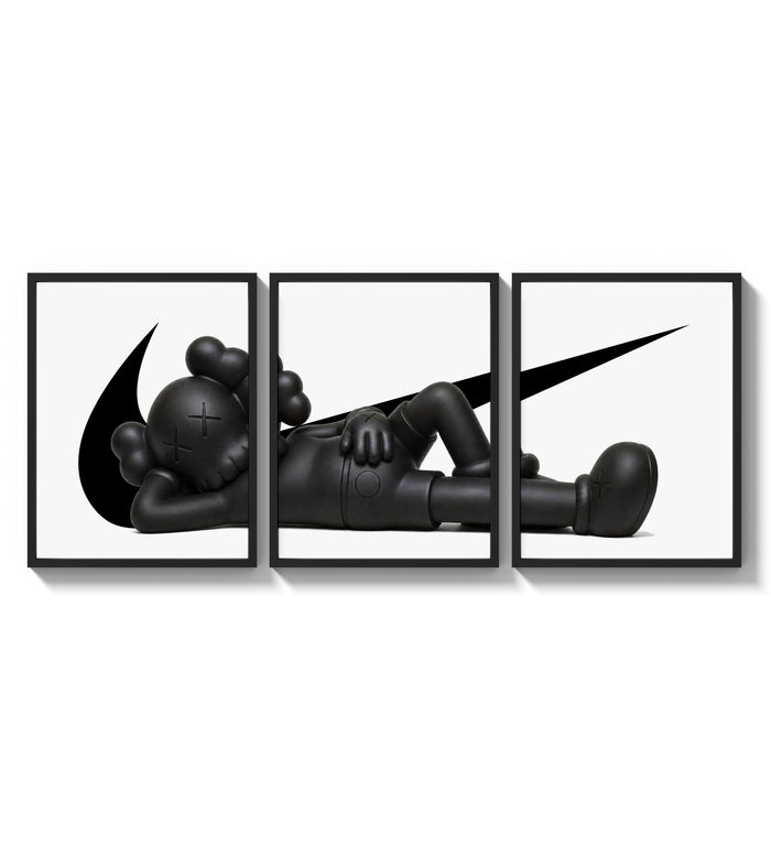 Reclining black KAWS Companion framed poster set of 3 with swoosh marks three-panel set arranged as a triptych on a…