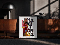 Black-framed Lewis Hamilton 44 Ferrari red framed F1 poster with cut-out type print on a moody console with designer…