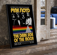 Pink Floyd vintage concert style framed poster with rainbow prism print in a black frame leaning beside a vintage door on…