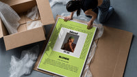 Man covering face album cover framed print being unpacked from protective bubble wrap and a box
