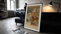 Church bells and snowy winter village print in a slim black frame leaning on a dark sofa in a concrete print studio