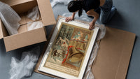 Church bells and snowy winter village framed print being unpacked from protective bubble wrap and a box