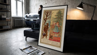 Man carrying turkey and girl decorating tree print in a slim black frame leaning on a dark sofa in a concrete print studio