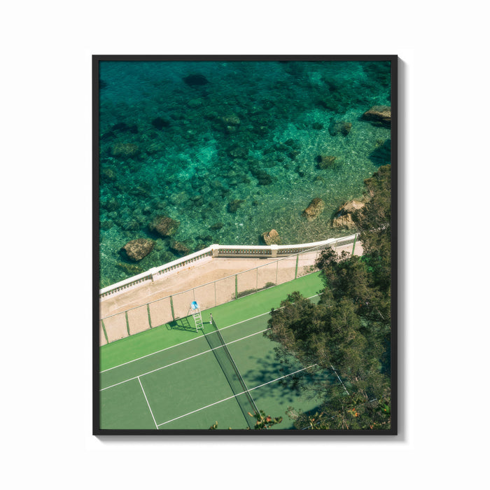 Framed Seaside tennis court by ocean print shown as a bold statement piece on a clean gallery wall