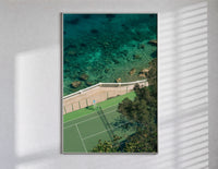 Seaside tennis court by ocean poster in a slim frame on a bright wall with soft window light