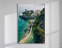 Cliffside coastal luxury villa estate poster in a slim frame on a bright wall with soft window light