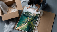 Cliffside coastal luxury villa estate framed print being unpacked from protective bubble wrap and a box