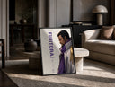 Anime marine admiral profile portrait print in a black frame leaning on a travertine table in a sunlit lounge
