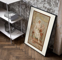 Elegant woman in white dress poster in a black frame leaning beside a shelf in a raw-plaster loft