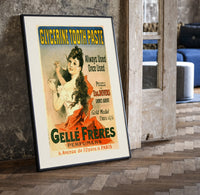 Woman brushing teeth with toothpaste print in a black frame leaning beside a vintage door on parquet