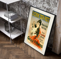 Woman brushing teeth with toothpaste poster in a black frame leaning beside a shelf in a raw-plaster loft
