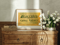Vintage French perfume label print in an oak frame on a farmhouse dresser beside white tulips
