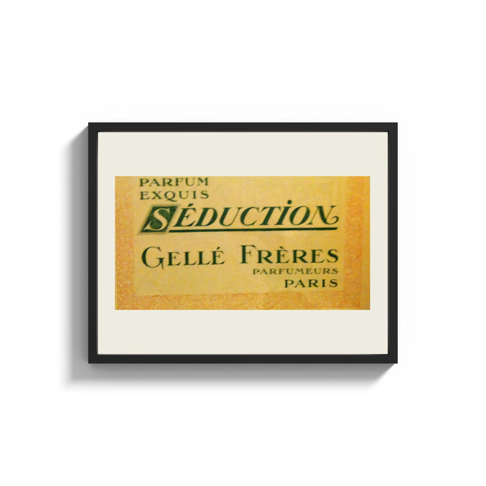 Framed Vintage French perfume label print shown as a wide statement piece on a clean white wall