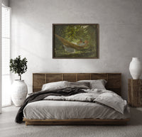 Girl reading in a hammock print in a dark wood frame above a rattan bed on a plaster wall