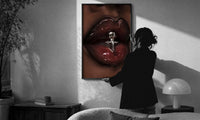 Glossy Lips with a Silver Charm print in a slim black frame being hung on a sunlit wall in a monochrome room