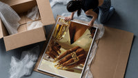 Gold Nails and a Stemmed Glass framed print being unpacked from protective bubble wrap and a box