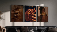 Gold Rings and Chains Set of 3 in black frames on a grey wall above a leather sofa