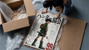 Anime boy with backpack and fishing rod framed print being unpacked from protective bubble wrap and a box