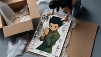anime boy in fighting stance framed print being unpacked from protective bubble wrap and a box