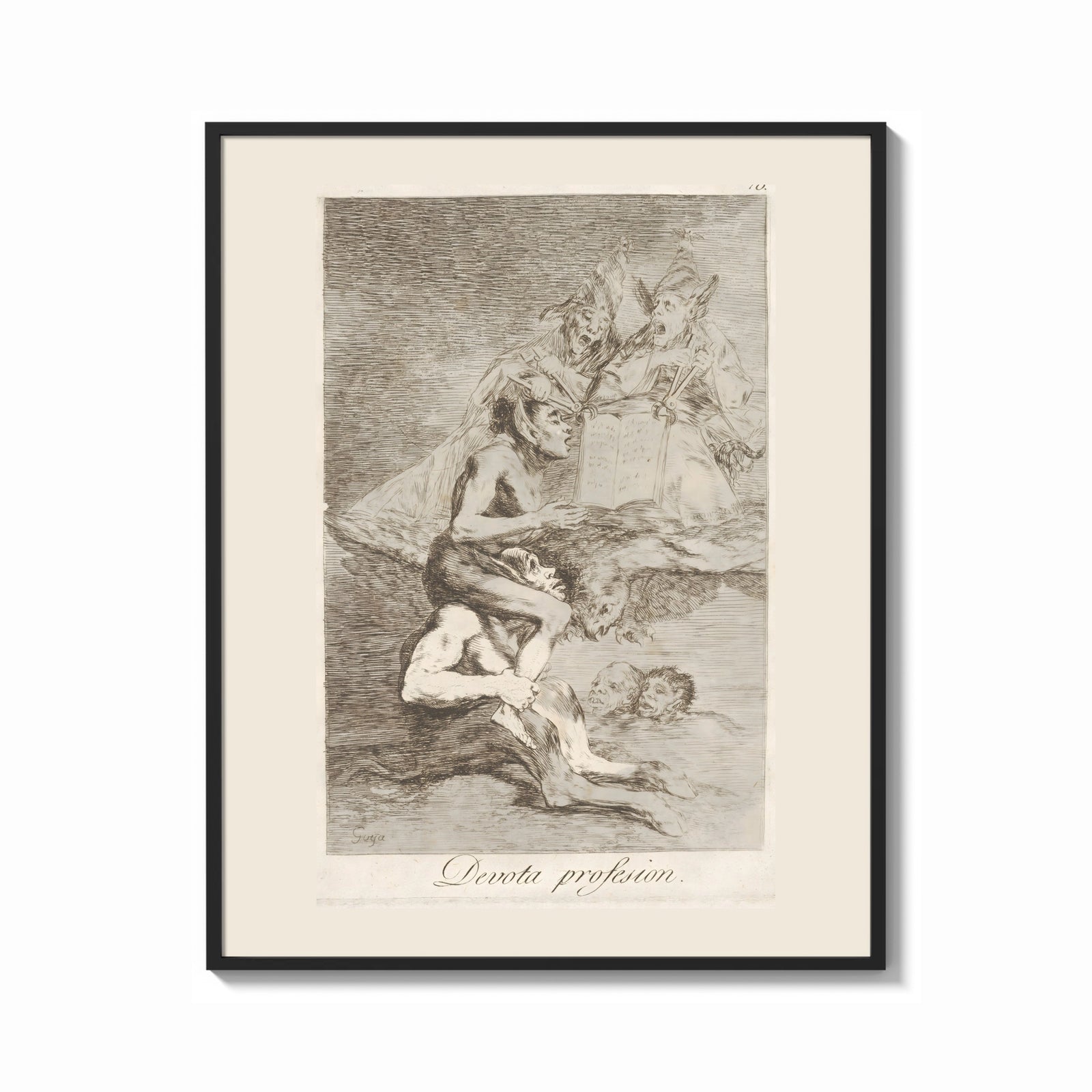 Framed grotesque devils and figures with book print shown as a bold statement piece on a clean gallery wall