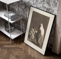 Mother with children fearing hooded figure poster in a black frame leaning beside a shelf in a raw-plaster loft