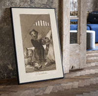 grotesque goblins drinking together print in a black frame leaning beside a vintage door on parquet