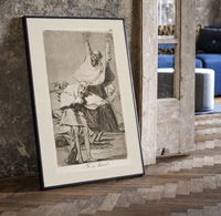 Grotesque figures screaming with raised arms print in a black frame leaning beside a vintage door on parquet
